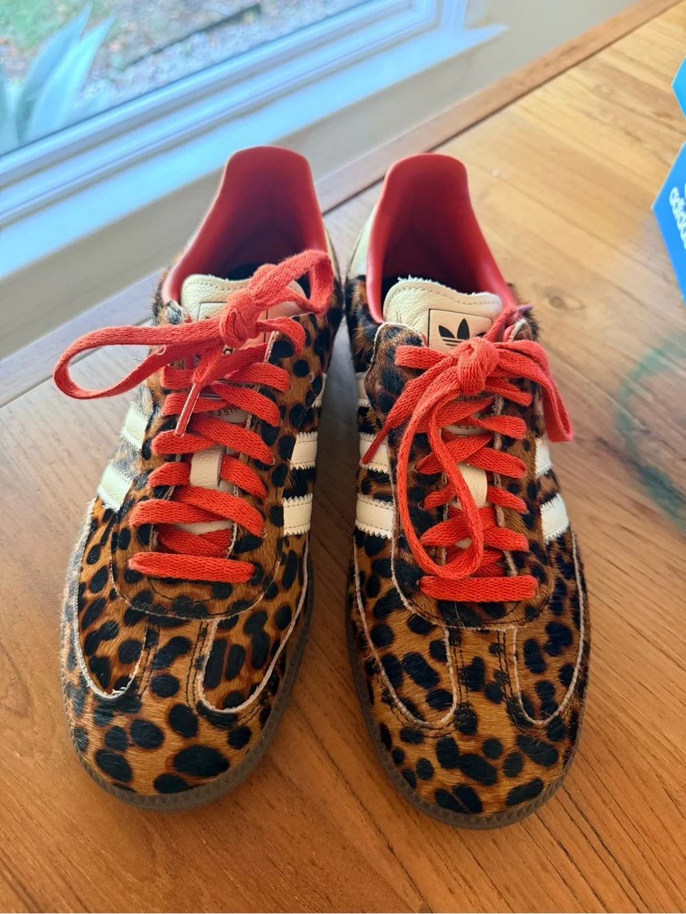 Adidas Originals samba sneakers in leopard print with red and white laces.